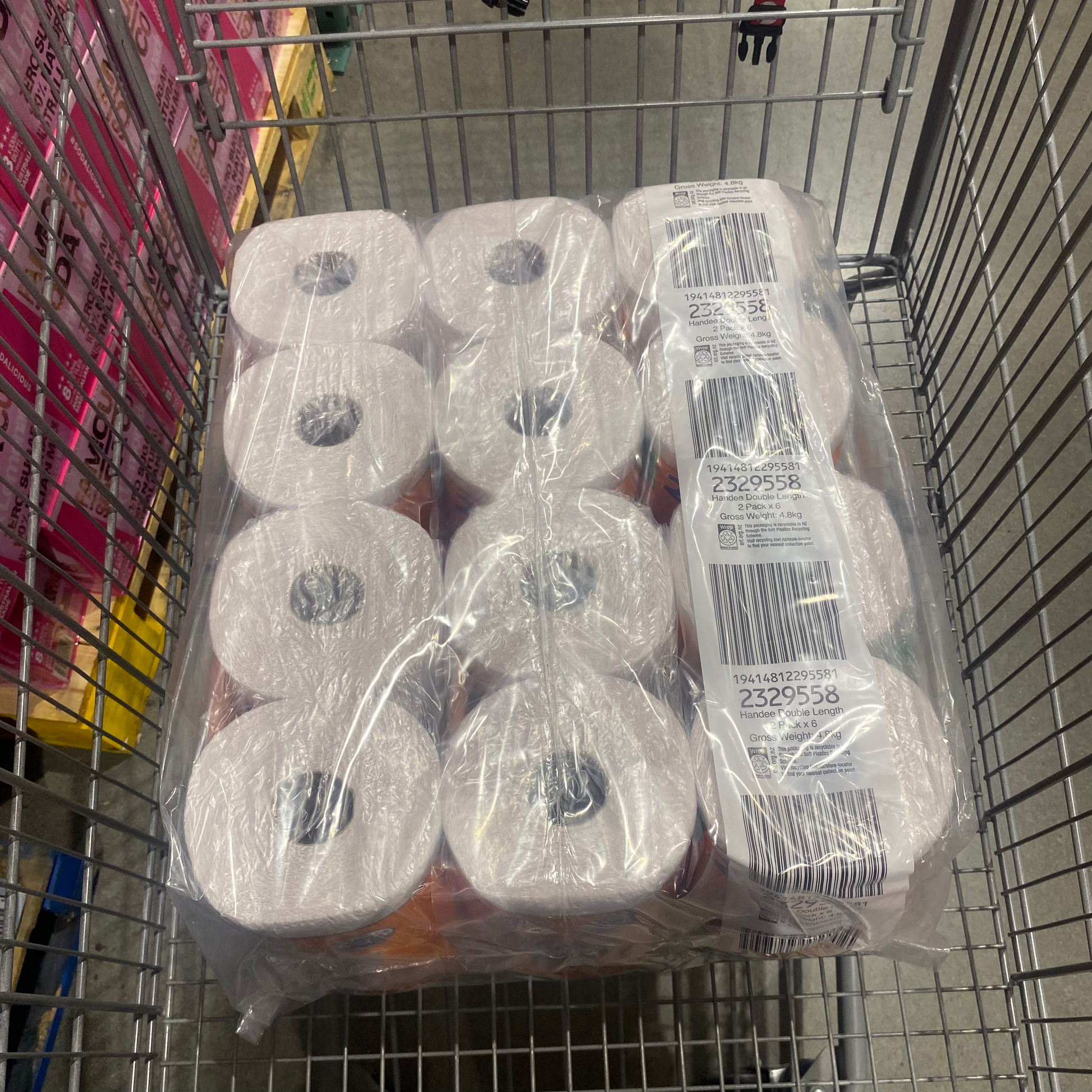 Pack on 12 Paper Towels wrapped on a plastic covering on a shopping cart