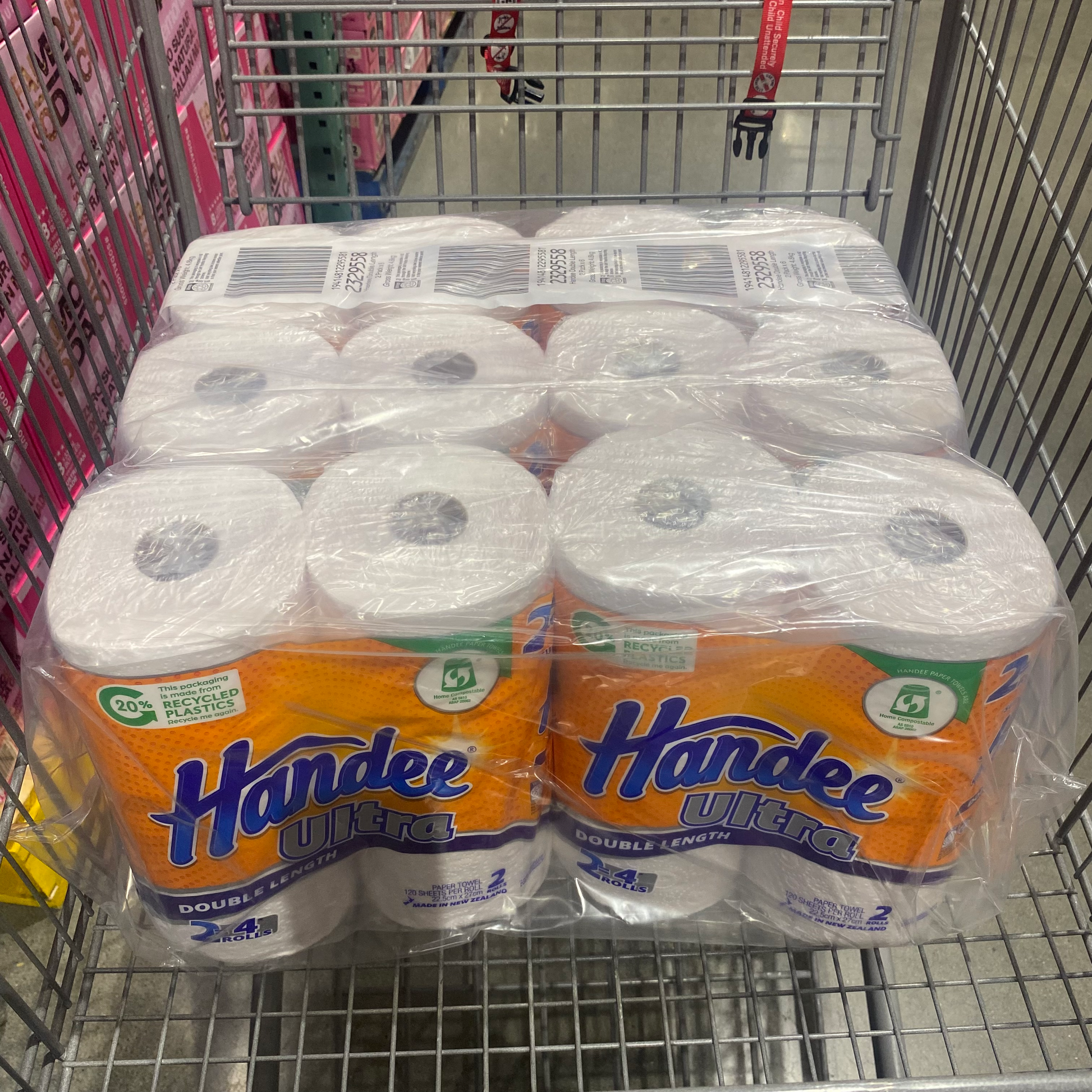 Pack on 12 Paper Towels wrapped on a plastic covering with branded name Handee Ultra Double Lengthon a shopping cart