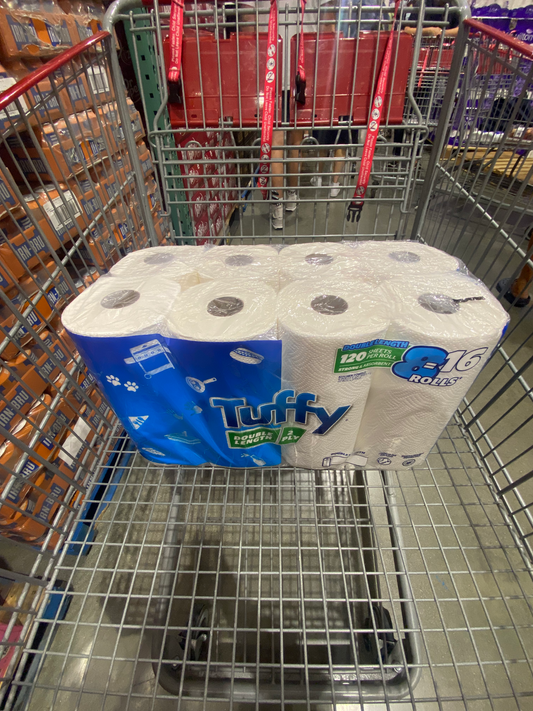 8 pack of paper towels wrapped in a plastic covering with brand name Tuffy Paper Towel front on a shopping cart for sale for costco online shopping. 